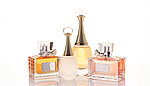 A collection of elegant perfume bottles arranged aesthetically on a reflective surface, highlighting luxury and personal style.