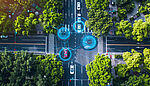 Aerial view of autonomous vehicles moving through a city intersection, overlaid with digital graphics indicating advanced navigation technology and connectivity