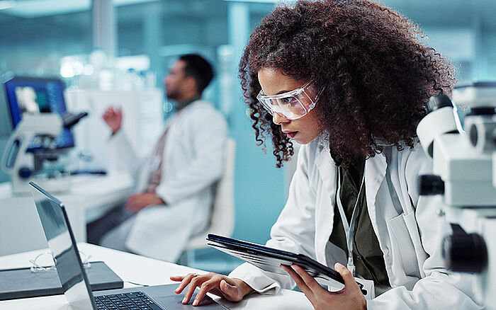 A researcher analyzes pharmaceutical data on a digital interface—advancing second medical use innovations through targeted compound repurposing.